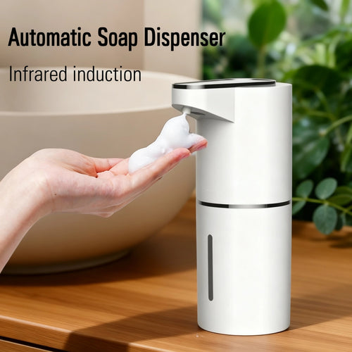 Automatic soap dispenser with infrared induction on a wooden surface, with a hand holding soap.