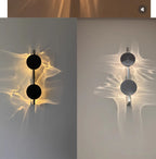 Modern wall sconce with abstract light patterns on a neutral background