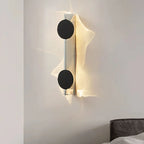 Modern wall lamp with black circular design on a white wall
